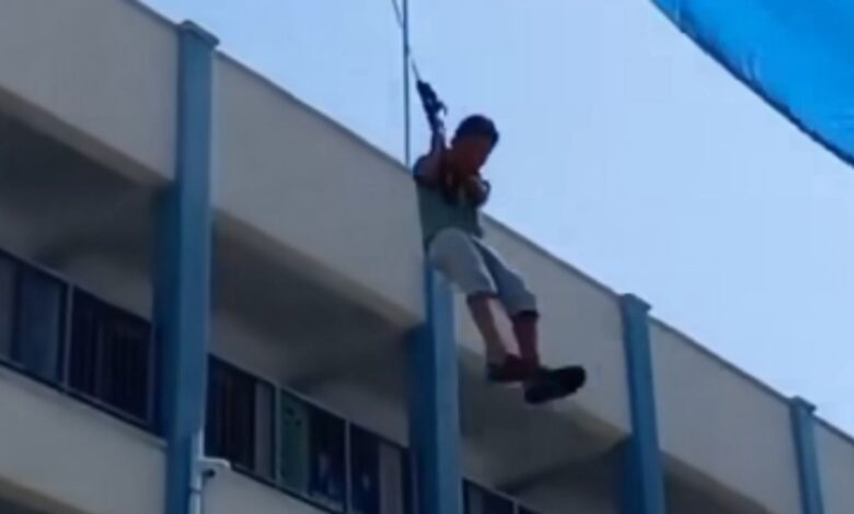 Niño se eleva más de cuatro pisos al tratar de sostener una lona: VIDEO